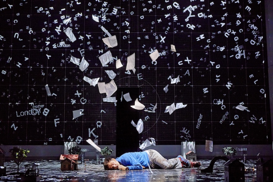 Man lying on the floor as paper rains down on him