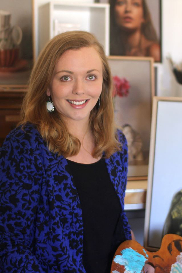 Headshot of Casey Thornton. She appears to be in her studio and holds and easel.