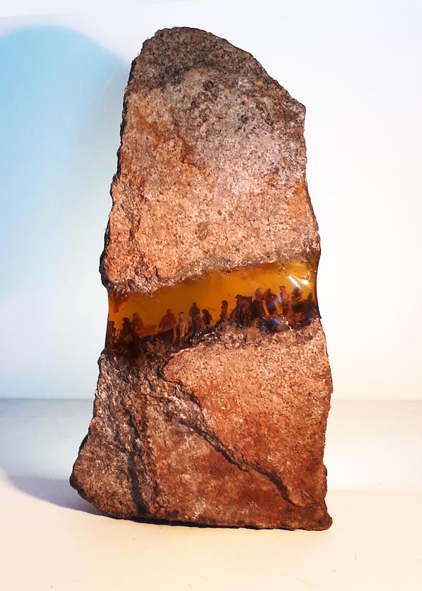Britt Mikkelsen’s breathtaking sculptural work suspends miniature human figures in resin between two layers of stone