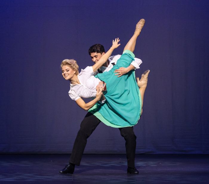 a man lifts a girl in an elegant dance hold