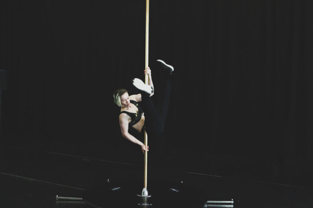 Sarah Chaffey holds herself aloft on a pole.