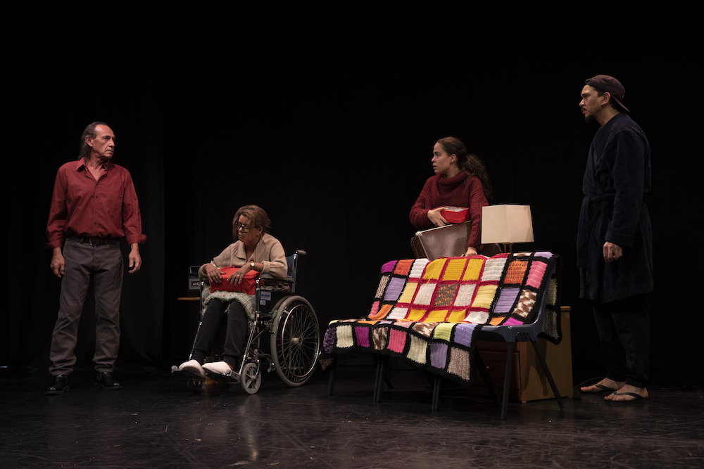 A scene from Yirra Yaakin's Vignette Series in which four people are frowning at one another. One is in a wheelchair, the rest stand.