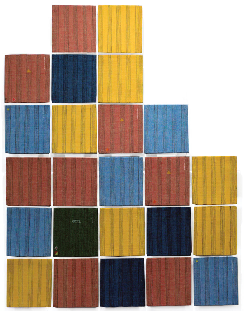 A series of coloured squares o fabric, stacked like tetris, one on top of each other.