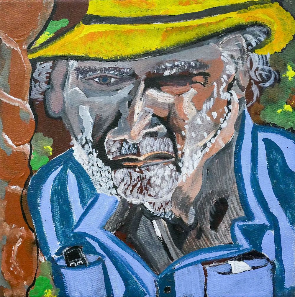 A Lester Prize painting of a First Nations man - he wears a bright yellow hat and bright blue shirt. One eye is squinting.