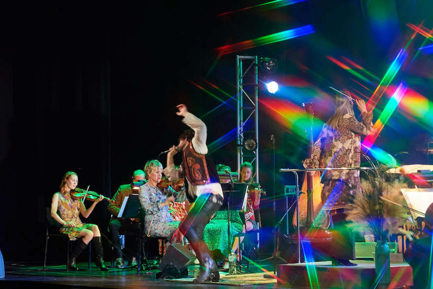 Rainbow coloured lights shoot across the stage as a singer clad in leather pants bends into the microphone, an orchestra behind him. It is Perth Symphony Orchestra's performance of The Doors.