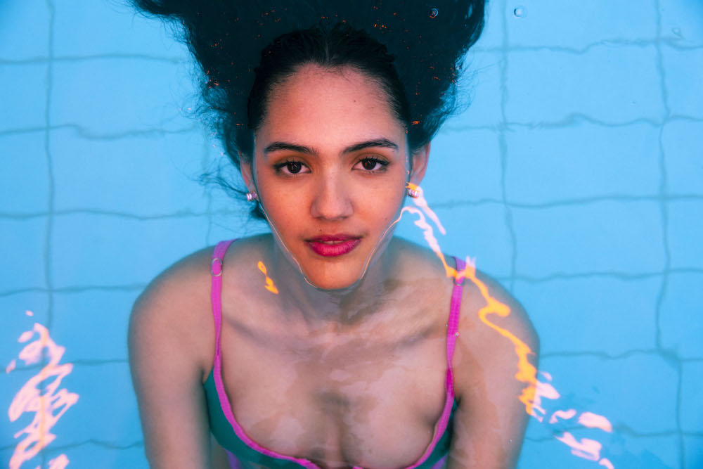 A woman with dark hair is submerged in a swimming pool, her face just above the surface. She is looking directly at the camera.
This is promo shot from 600 Seconds - HITT, part of Fringe World.