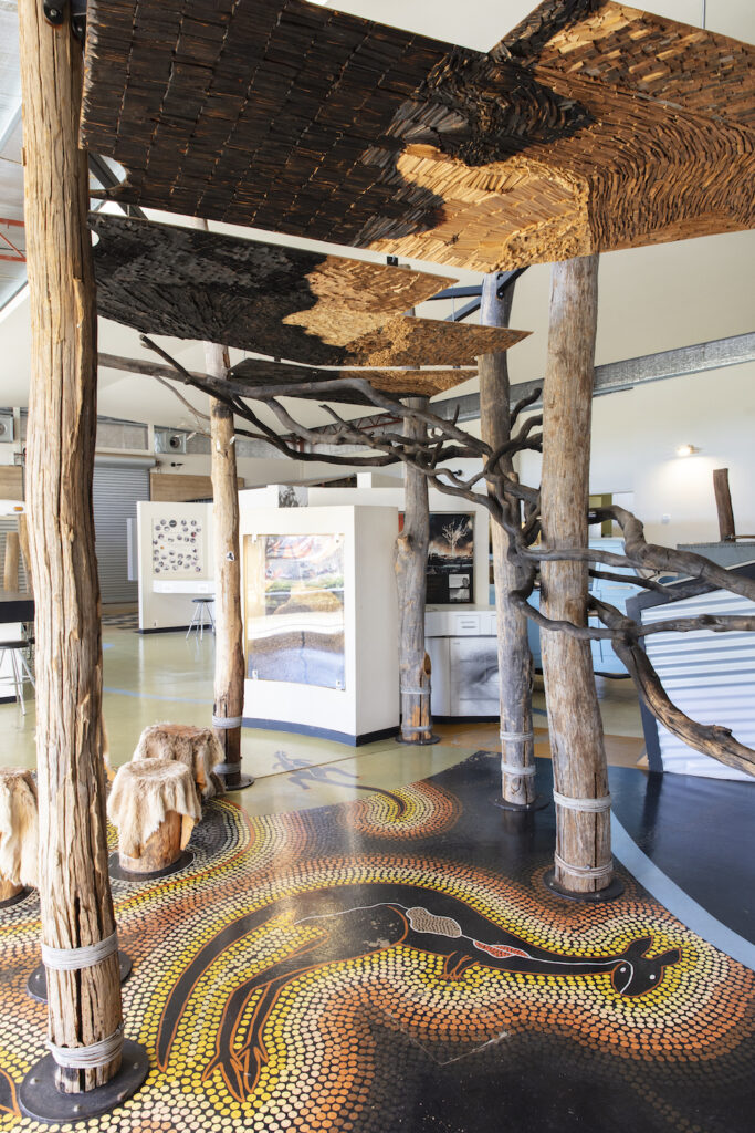 The interior of the Kodja Place, which includes a model of a Noongar shelter and traditional dot art on the ground.